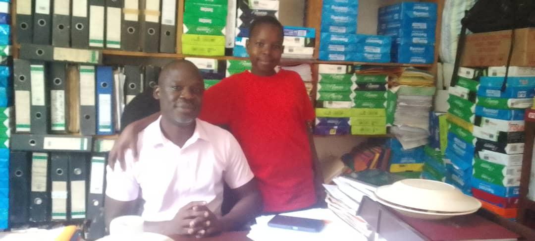 Keren Mungunuti and the Headteacher of Charity College Paidha Andrew Olweny.