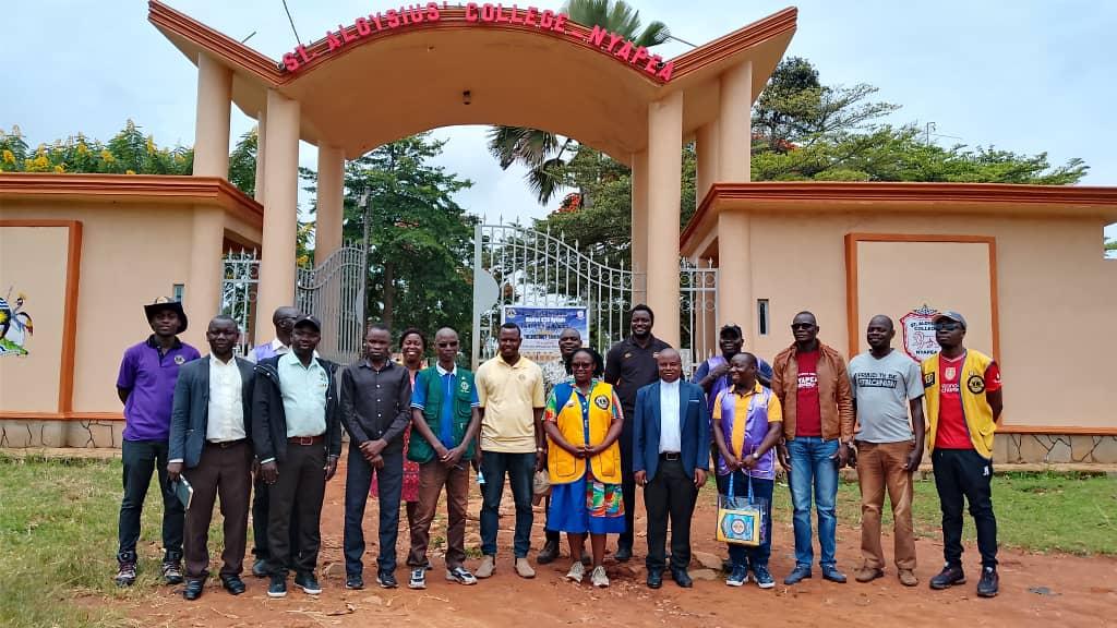 Lions Clubs International District Governor Allen Tush Naturinda posed for a photo with members of Nyapea and Arua lions clubs at St Aloysious College Nyapea on August 17, 2025 .