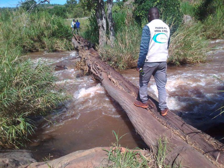 A journalist crossing the deplorable Nyagak Paa Bruno footbridge at Yil village, Anyola Parish, Atyak Sub-County, Zombo District.photo/Mike Rwothomio