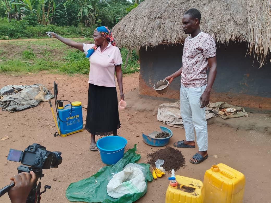 A farmer and her community facilitator takes  the journalists through the Processes of producing Bio liquid fertilizer in Ayida Village, Pakia Parish, Warr Sub-County Zombo District on September 18, 2025.