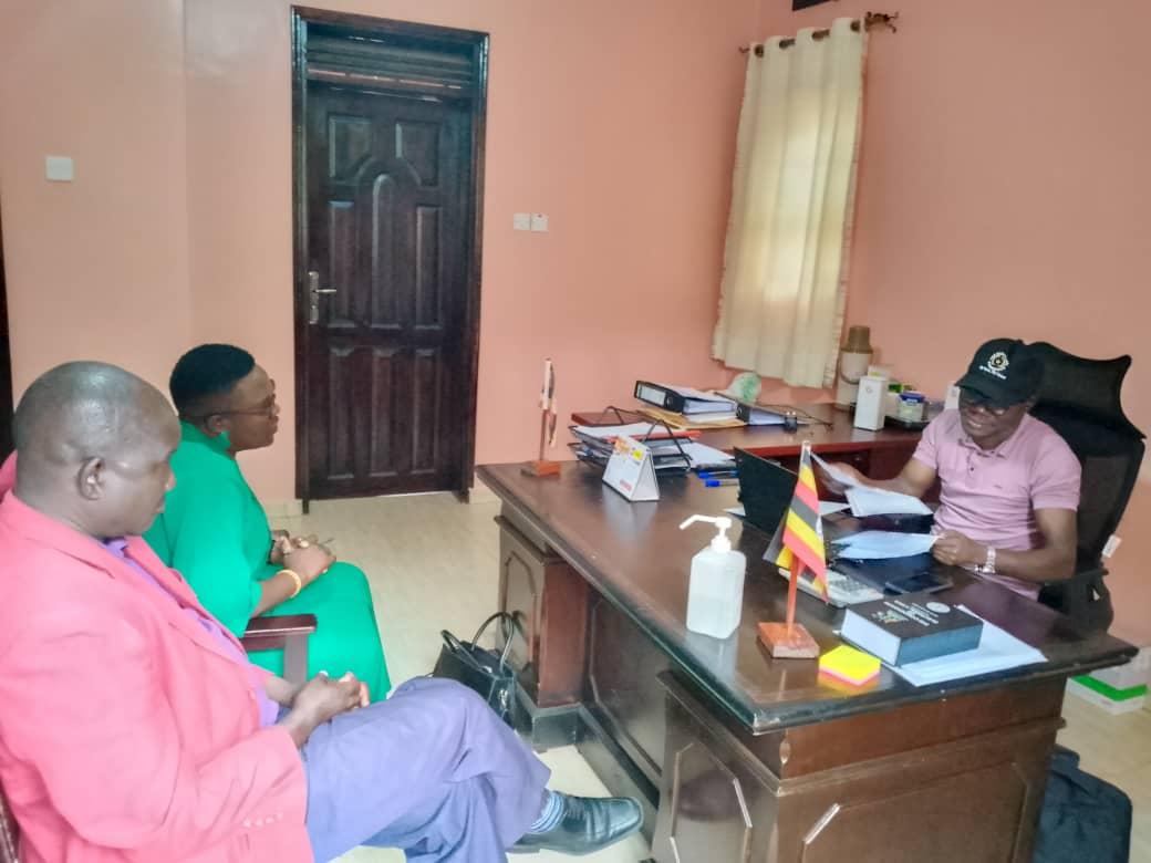 Emmanuel Ogwang, Zombo's Returning Officer hands over Nomination forms to Adong Sarah at Electoral Commission Offices in Paidha town council on October 2, 2025.