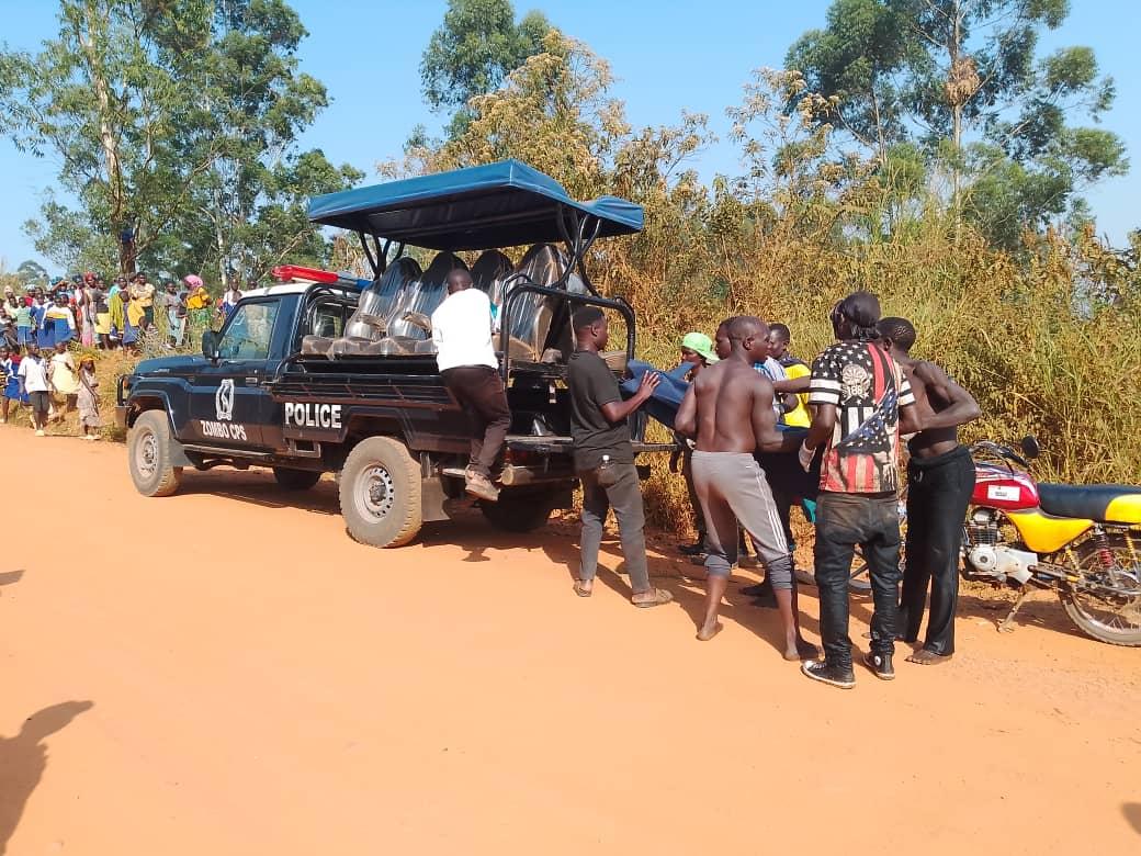 Local divers transport the body to a waiting police van at Nyagak river on February 25, 2026.Photo.Mike Rwothomio