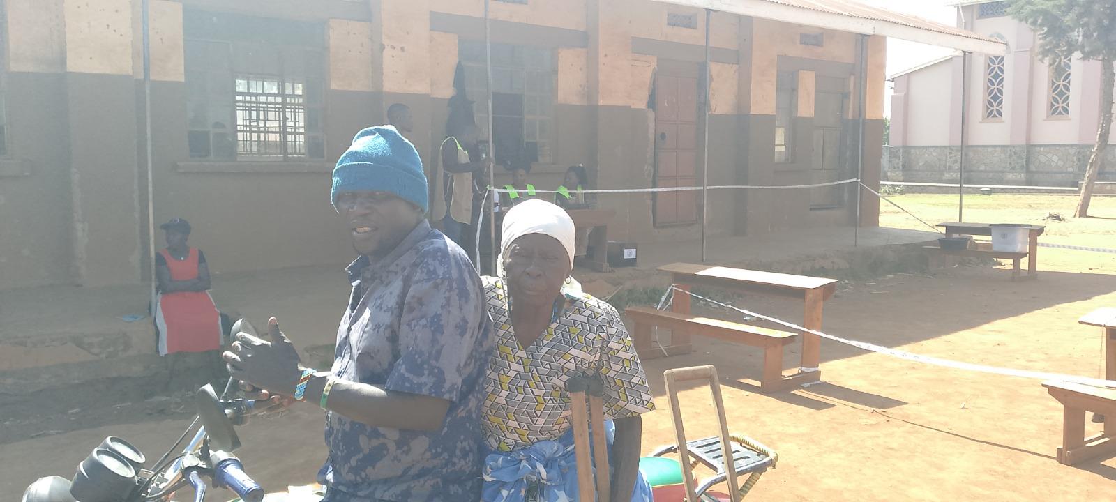 Elderly mother arrives at Utrgan Mission Polling station to cast her vots thius morning. Photo by Alex Pithua