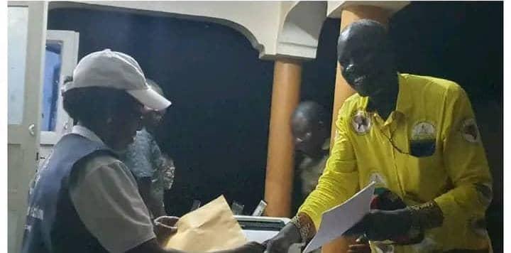 Pakwach Returning Officer Sarah Nabukera hands over Declaration form to Okumu Robert Arule at EC offices in Pakwach last week Photo / Pakwach FM