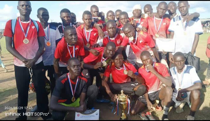 Pakadha Seed Secondary School Boys team posed for a photo with a trophy