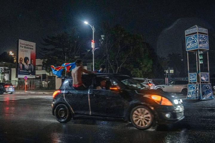 Congolese supporters celebrate in the streets following their team’s victory in 2026 FIFA World Cup qualifiers final playoff football match between the Democratic Republic of the Congo and Jamaica, in Kinshasa early on April 1, 2026. (Photo by Glody MURHABAZI / AFP)