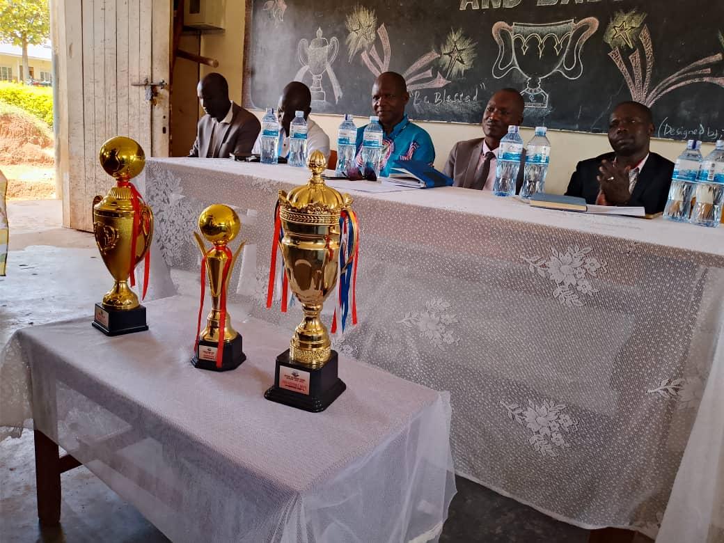 The three trophies won by Pakadha Seed Secondary School displayed in front of district officials during the Thanksgiving prayers on Friday, April 10, 2026. Photo: Mike Rwothomio.