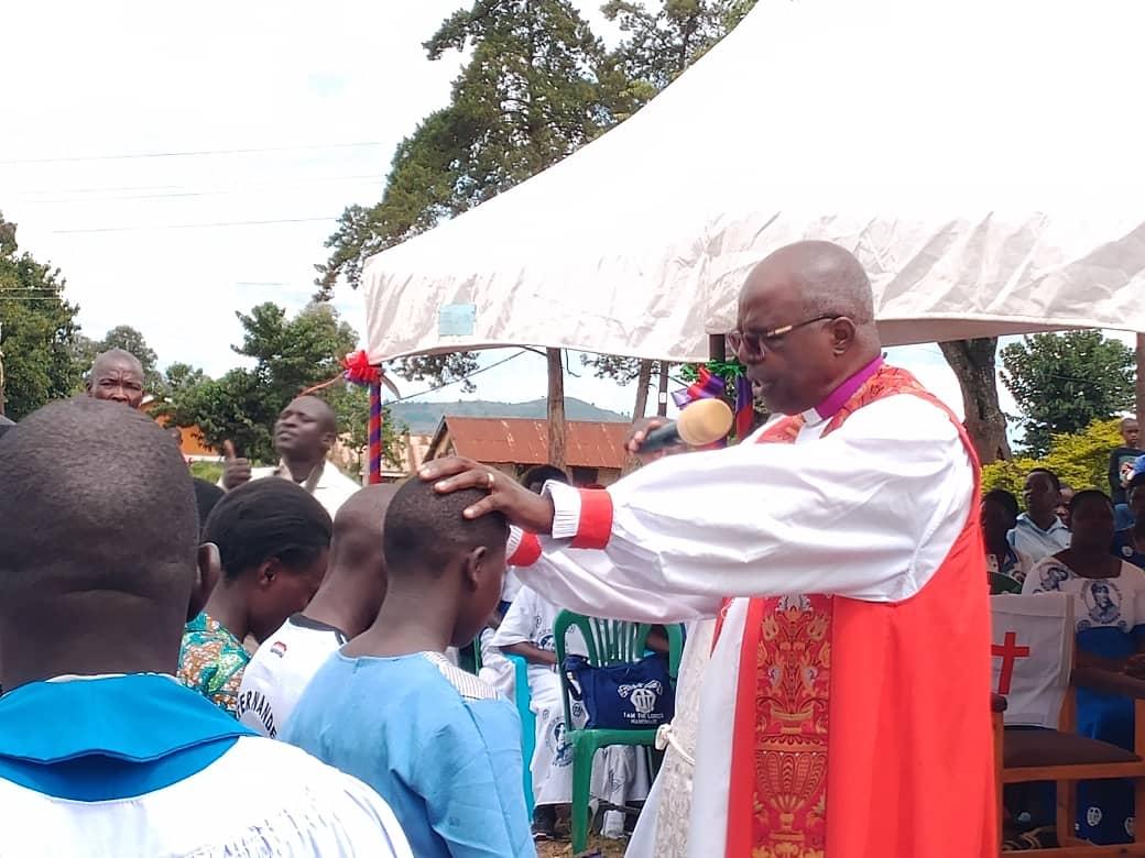 Retired Archbishop Dr. Henry Luke Orombi administer confirmation to the faithfuls at Mvungu upper Primary School Playground in Paidha town council on Sunday April 12, 2026.