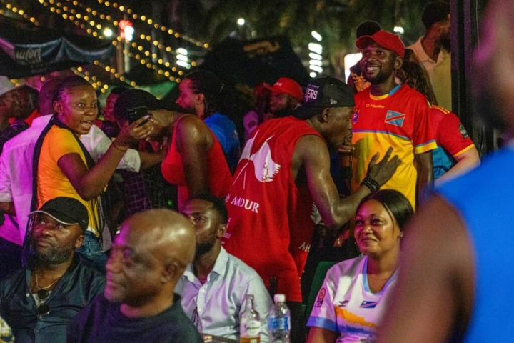 Congolese supporters react as they watch a broadcast from Zapopan, Jalisco state in Mexico, of the 2026 FIFA World Cup qualifiers final playoff football match between the Democratic Republic of the Congo and Jamaica, in Kinshasa early on April 1, 2026. (Photo by Glody MURHABAZI / AFP)