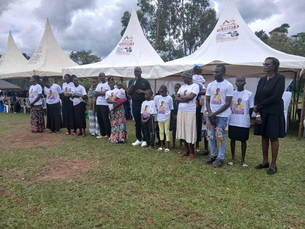 Zombo District Chairman LC5 James Oruna Oyulu (centre in black dress) introducing his siblings and their children present at the funeral ceremony of his mother, the late Natalina Oweci.