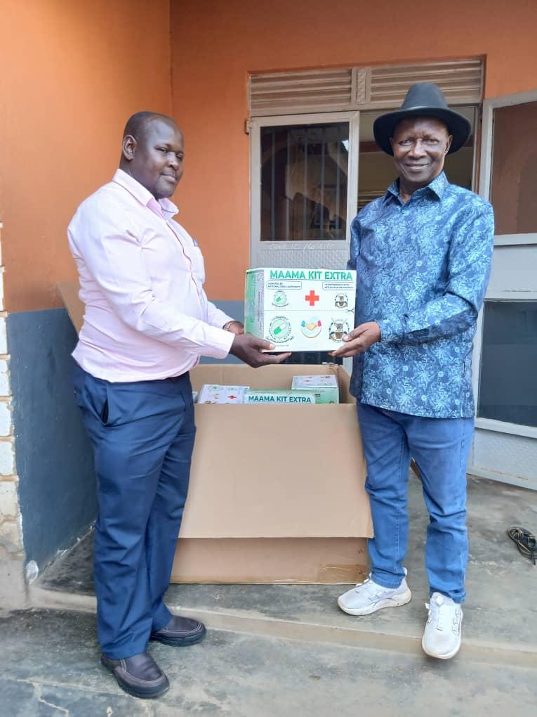 PRO NDA Fred Kabuye ( left) hands over the kits To Alur Kingdom Prime Minister Prince Lawrence Opar Angala on Monday June 22.