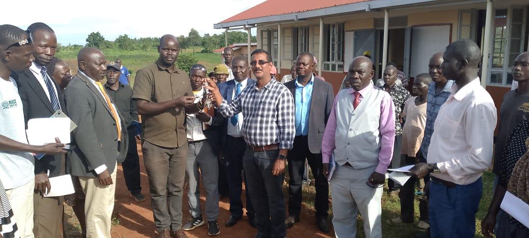 Zombo district officials receiving keys for Kango Seed Secondary schools from Newton Technical Services' director. (Photo by Alex Pithua)