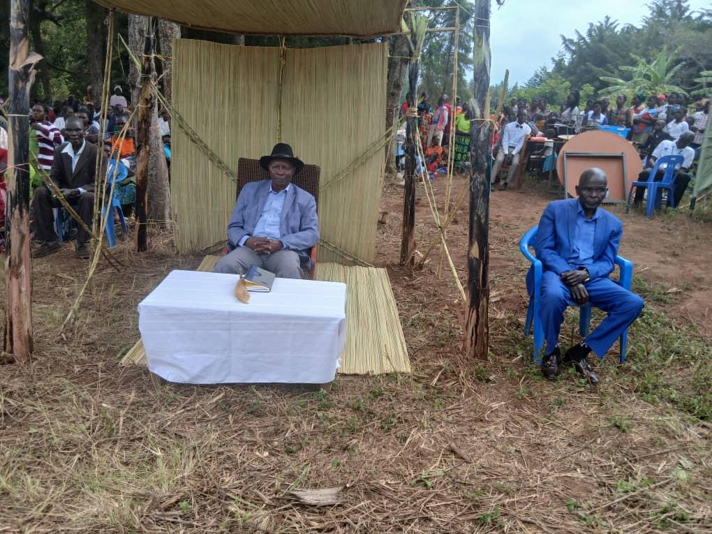 Jadipu (Prime Minister) Prince Lawrence Opar Angala (left) posed for a photo with Rev Father Moses Okwenuru after the Thanksgiving Ceremony.