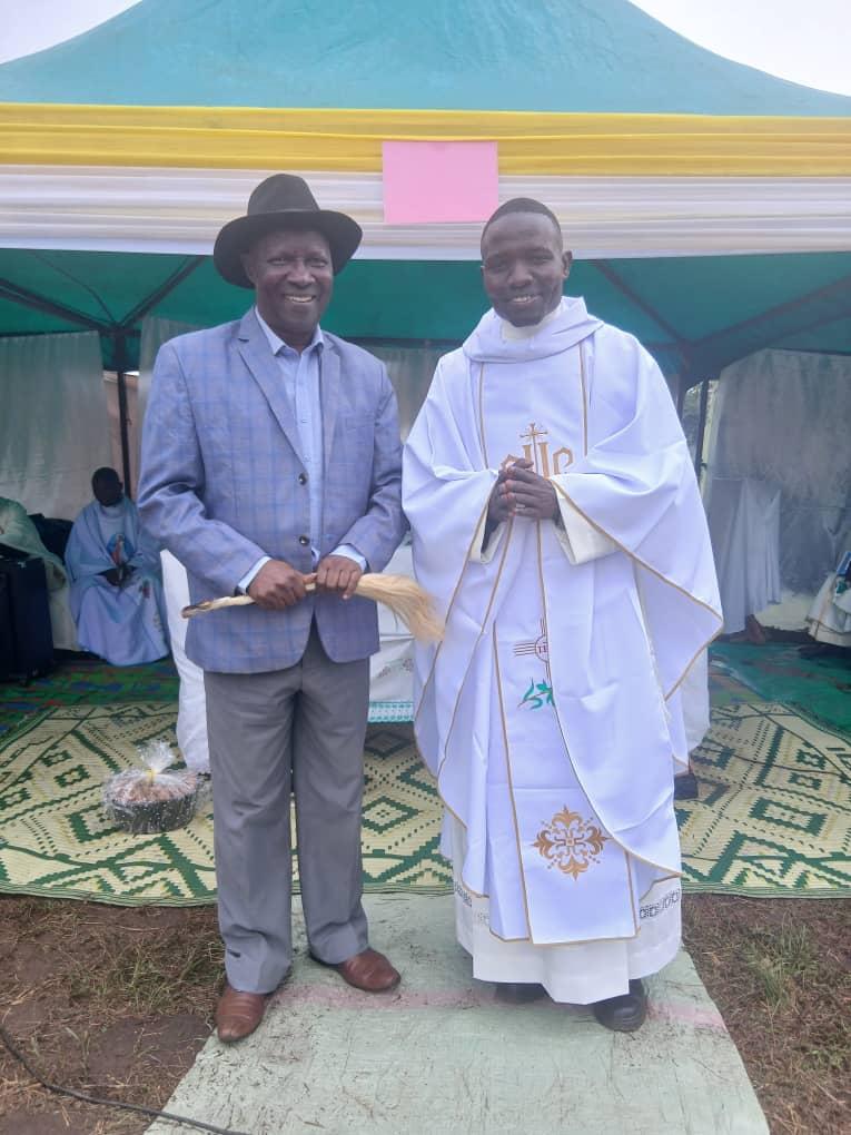 Jadipu (Prime Minister) Prince Lawrence Opar Angala (left) posed for a photo with Rev Father Moses Okwenuru after the Thanksgiving Ceremony.