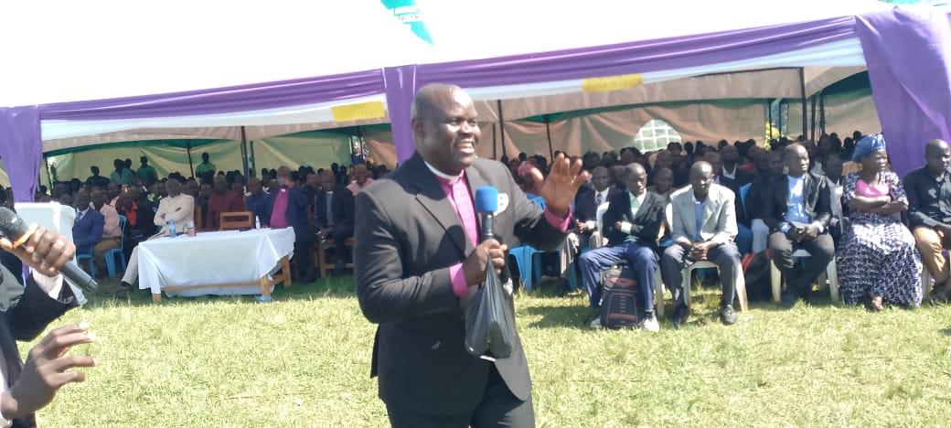 General Overseer Bishop Bagoza Charles preaching gospel to thousands of mourners during the burial of late Bishop John Okethwengu at Adhingi primary school in Zombo district. (Photo by Alex Pithua)