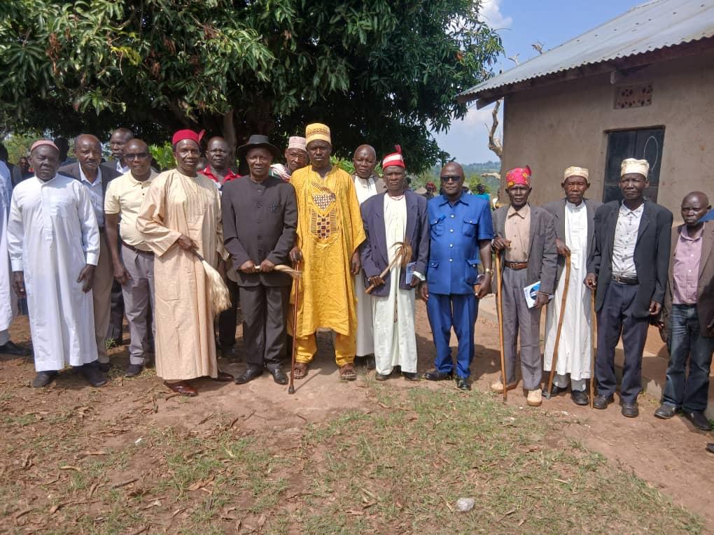 Jadipu Prince Lawrence Opar Angala (centre, in a black Kaunda suit and holding a fly-whisk) poses for a group photo with Ker Alur chiefs who attended the funeral service of the late Nyaluo Ucokuru Ulony Sammy Chimvor at Alia Church of Uganda Parish in Warr Town Council.