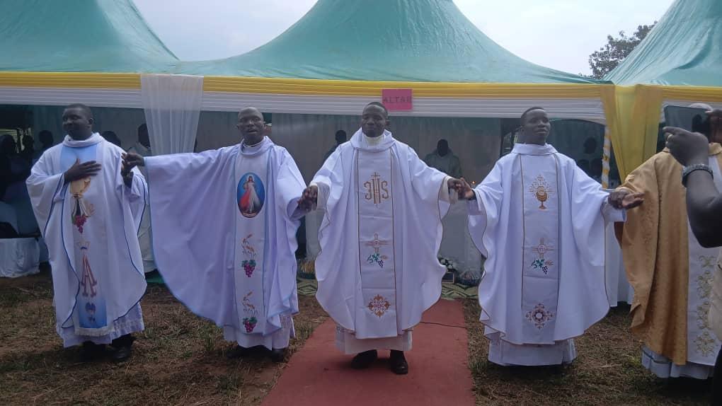 Jadipu (Prime Minister) Prince Lawrence Opar Angala (left) posed for a photo with Rev Father Moses Okwenuru after the Thanksgiving Ceremony.