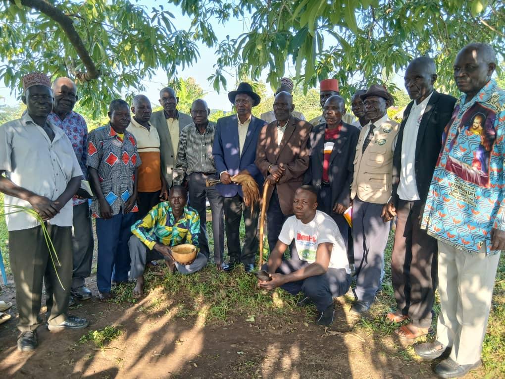 Jadipu Prince Lawrence Opar Angala (seated centre) sharing traditional meal with Mr Anthony Obima Ngomlokuju (on Jadipu's left) and Mr Joseph Opoka ( onJadipu's right) after successful mediation of the longstanding personal dispute that prevented the conclusion of an important Cultural ritual regarding Thumu Wanglei since 2006. The two reconciled and forgave each other and werecleansed through Yecu Ayiza ritual by Agulukongu Kwai Ocweda elders, Julam of Kaal Atyak Winam, according to Alur tradition in such circumstances.