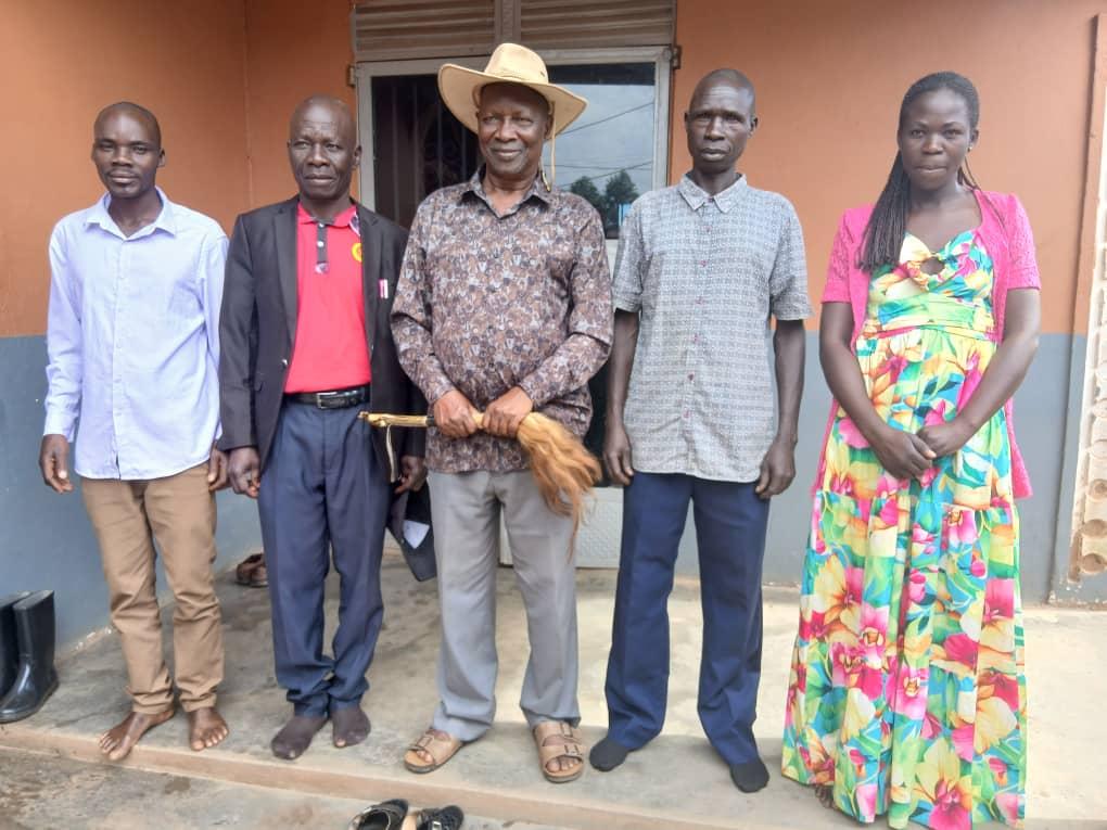 Jadipu Prince Lawrence Opar Angala (holding Fly-whisk) poses for group photo with the Acer Chiefdom Minister of Culture Ovoya John (in red shirt) who delivered the invitation letter and to Kaal Atyak and his office staff in Yamo Trading Centre, Atyak Sub-County in Zombo District.