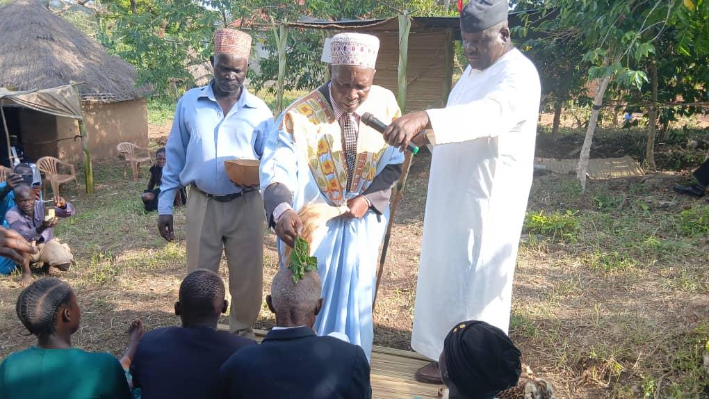 Newly installed Rwoth of Acer chiefdom Thowarac Samuel Cimvor 1V (seated left) and Ker Jadipu Prince Lawrence Opar Angala with Nebbi District Assistant RDC Owachgiu Donald (centre) and other government officials who attended the enstoolment ceremony.