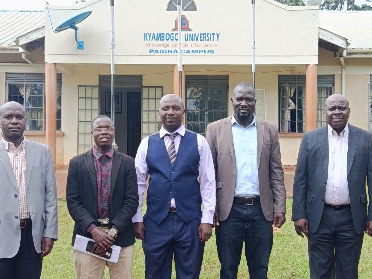Staff members and a student pose for a photo at Paidha Campus