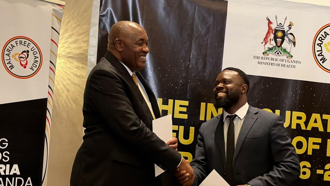 Health Minister Chris Baryomusi ( left) greets Bernard Feni (Right)